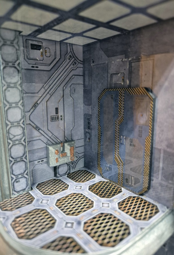 Interior of a futuristic sci-fi room with metallic walls, detailed circuit patterns, and a textured floor, featuring doors and a panel with wires.
